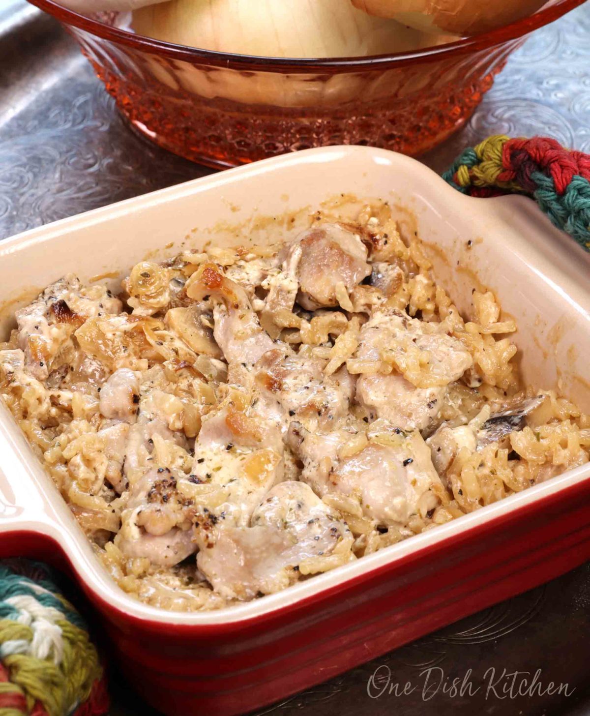 a small chicken and rice casserole in a mini red baking dish.