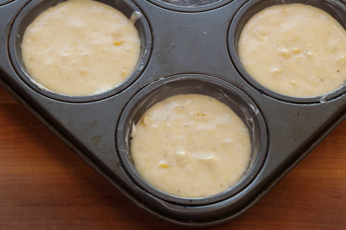 corn muffin batter in a muffin pan.