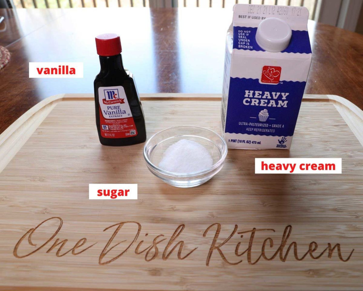 heavy cream, sugar, and vanilla on a wooden cutting board.