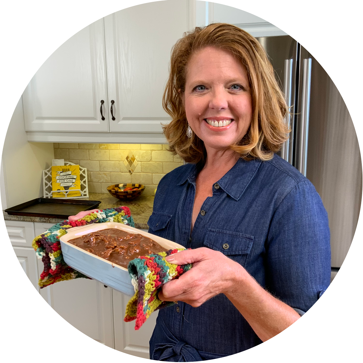 joanie zisk holding a mini chocolate cake.