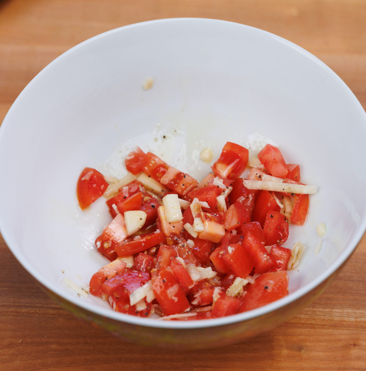 chopped tomatoes, garlic, olive oil, salt and pepper in a small bowl.