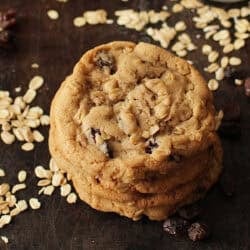 three oatmeal raisin cookies stacked on top of one another.