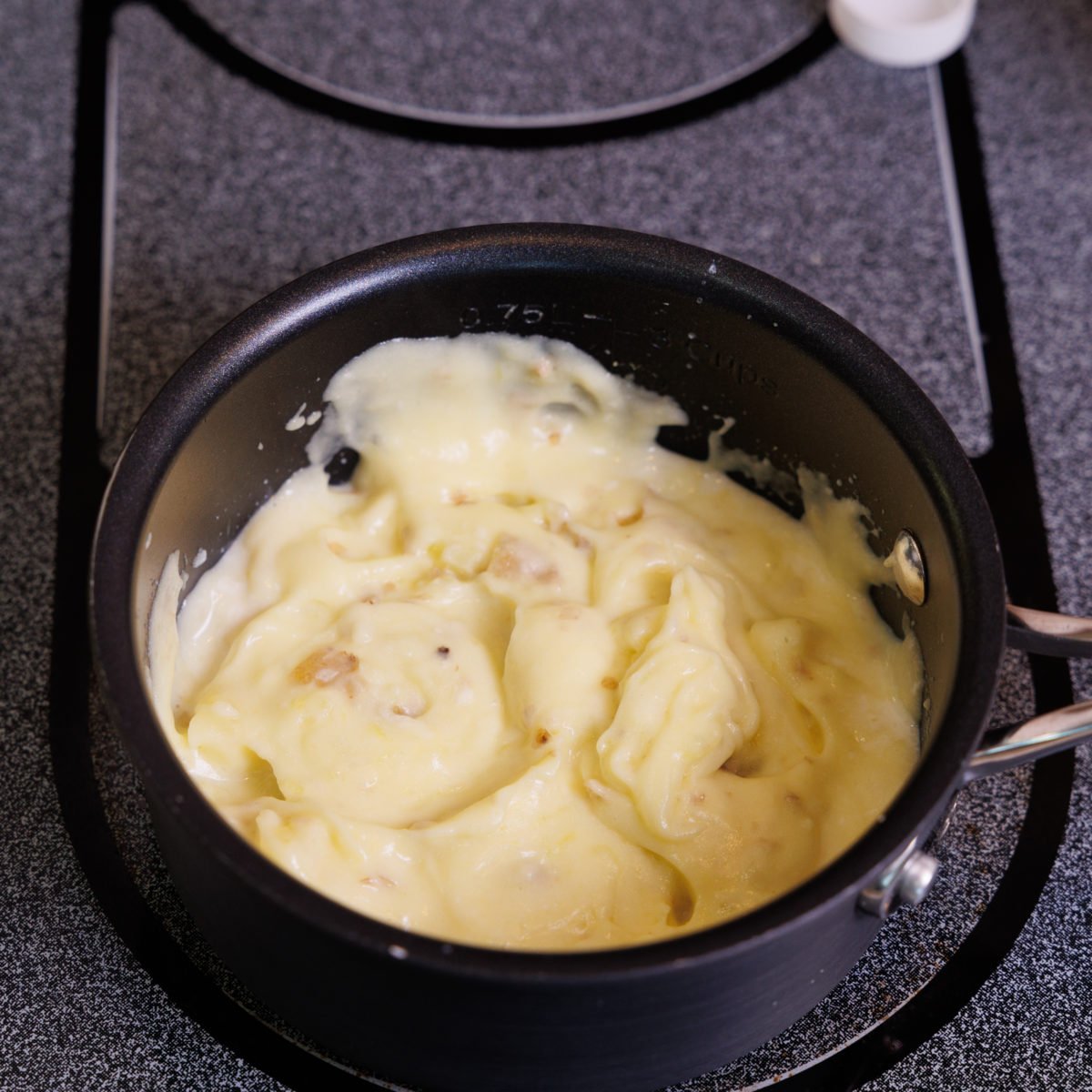 mashed potatoes in a small black pot.