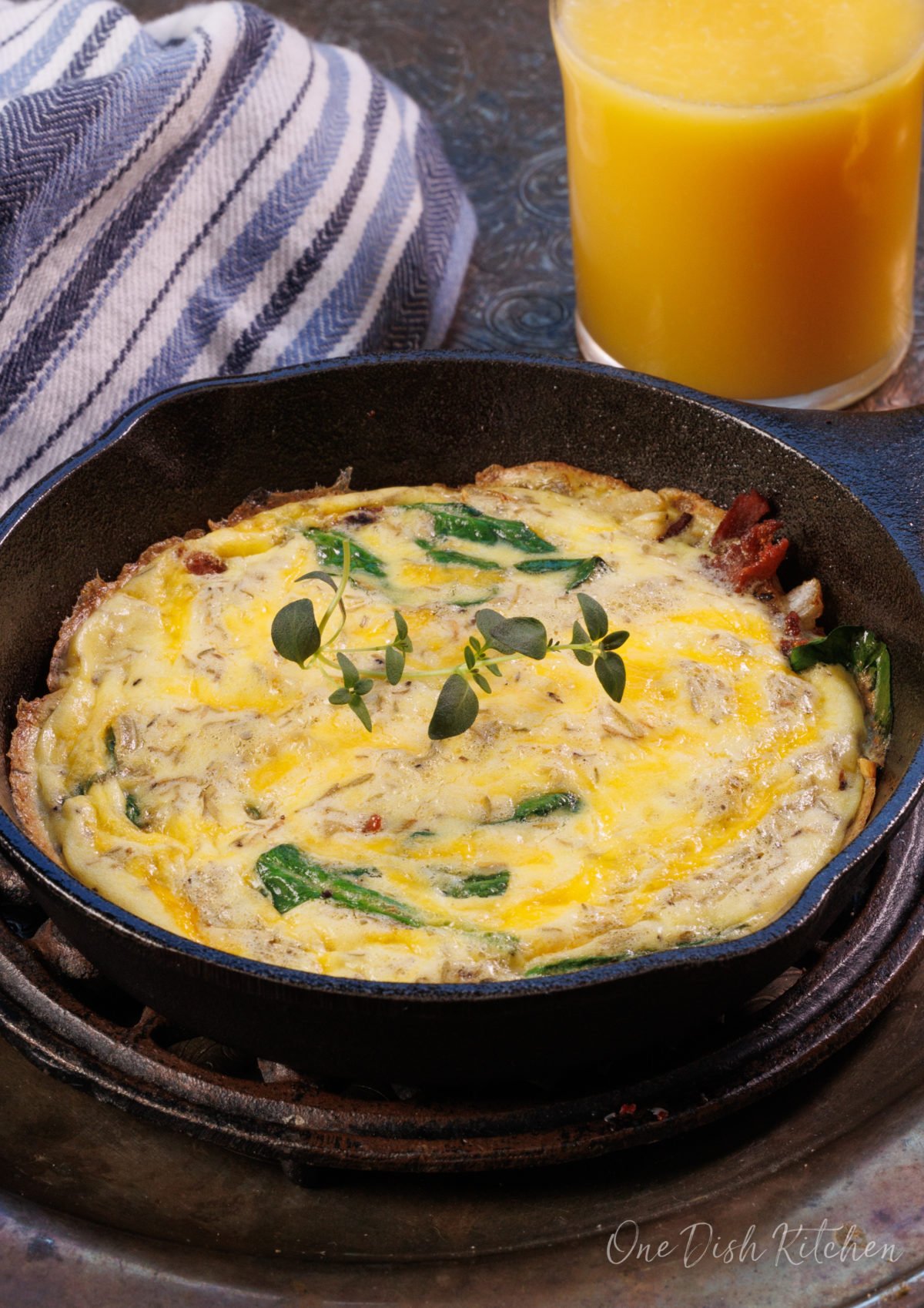 a mini spinach and bacon frittata in a small cast iron skillet.