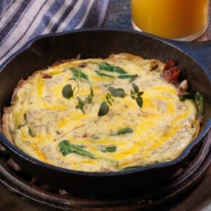 a mini spinach and bacon frittata in a small cast iron skillet