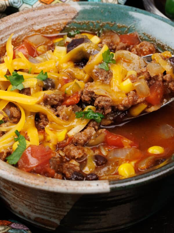 a bowl of taco soup topped with shredded cheese.