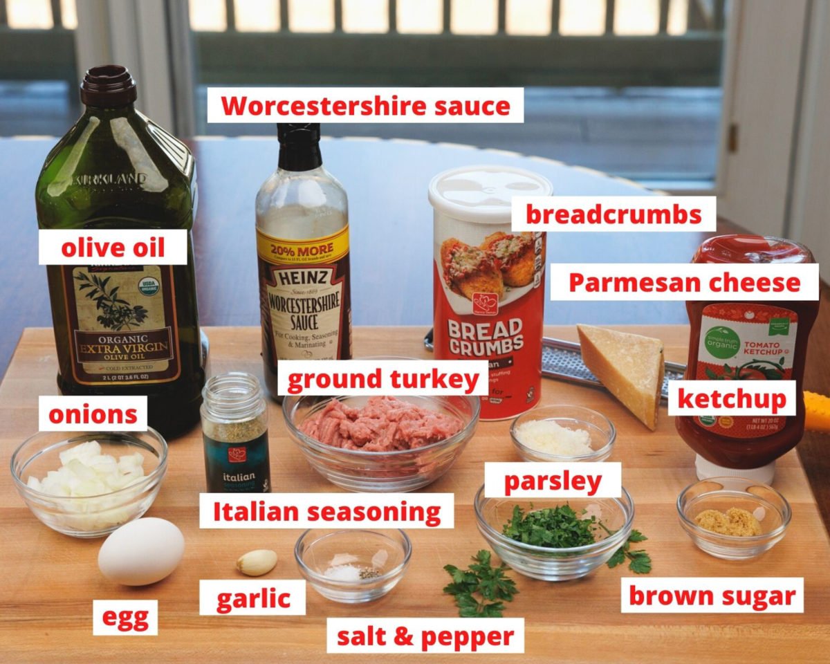 ingredients needed to make a small turkey meatloaf on a wooden cutting board.
