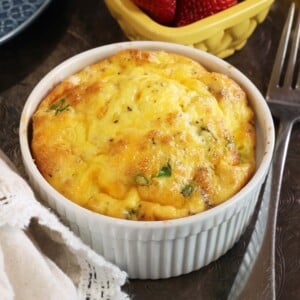 white ramekin filled with bacon egg and cheese casserole.