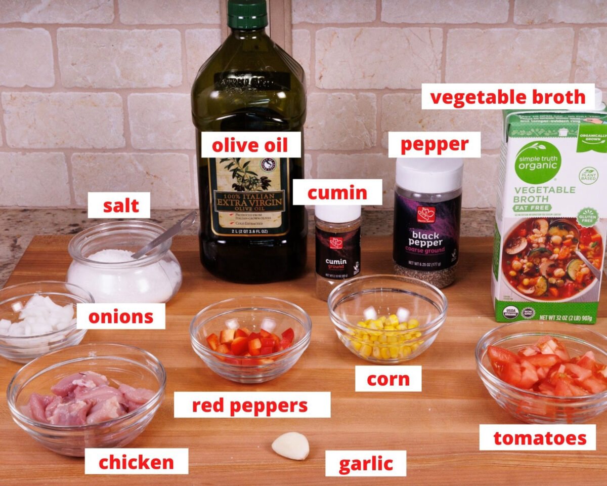 ingredients needed for chicken tortilla soup on a wooden cutting board.