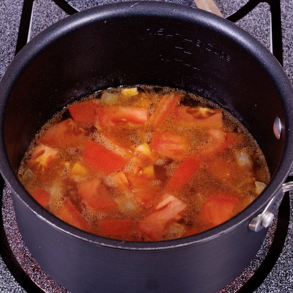 tortilla soup simmering in a small pot.