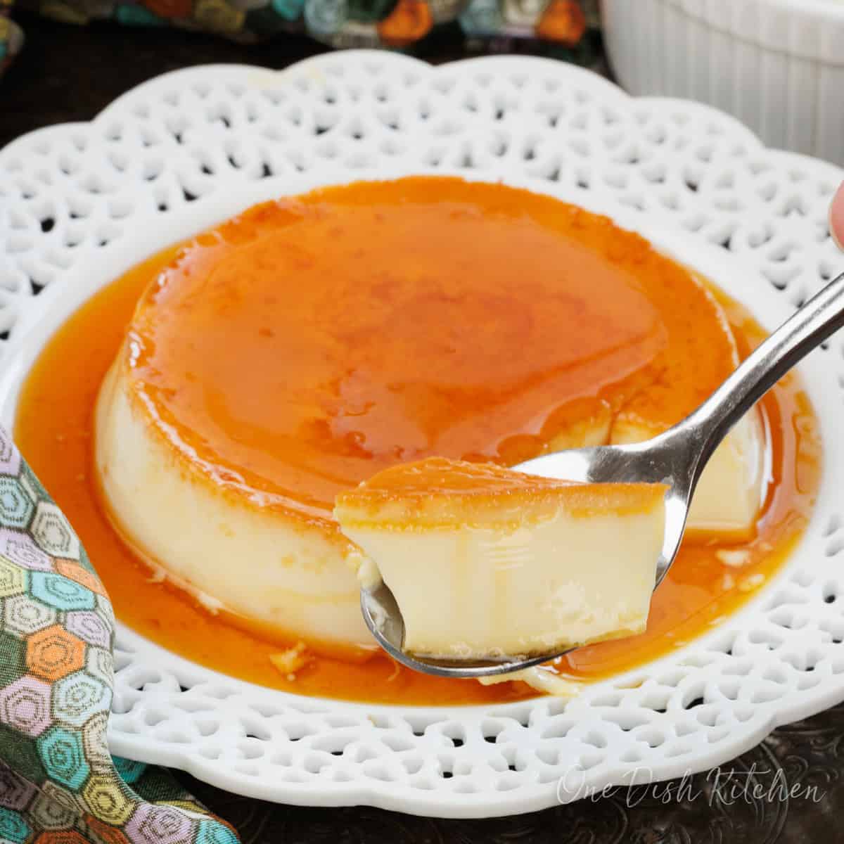 flan on a white plate with a fork on the side.
