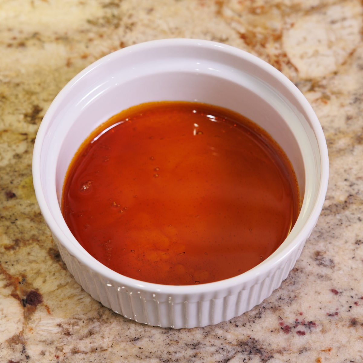 caramel in the bottom of a small ramekin.