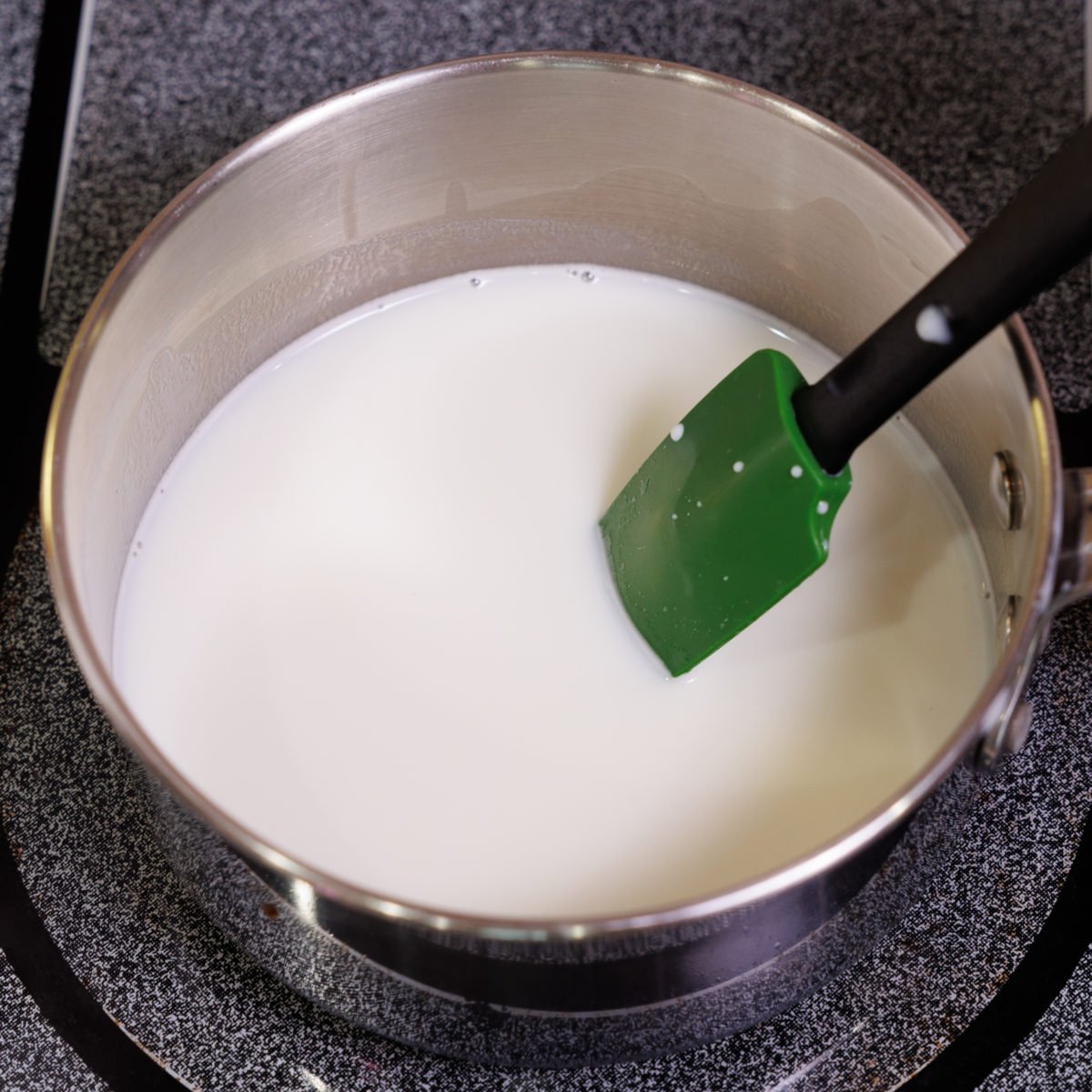 milk simmering in a small saucepan.