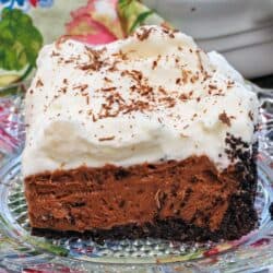 a slice of french silk pie on a clear plate.
