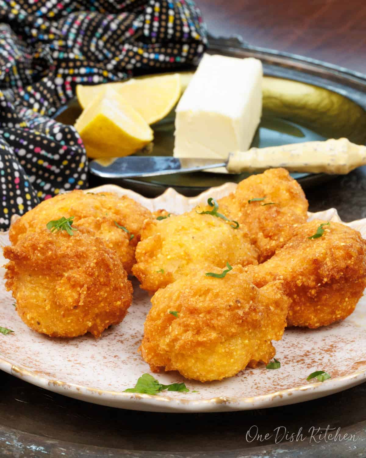 a single serving of hush puppies on a plate.