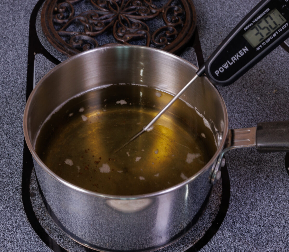 cooking oil heating in a small saucepan.