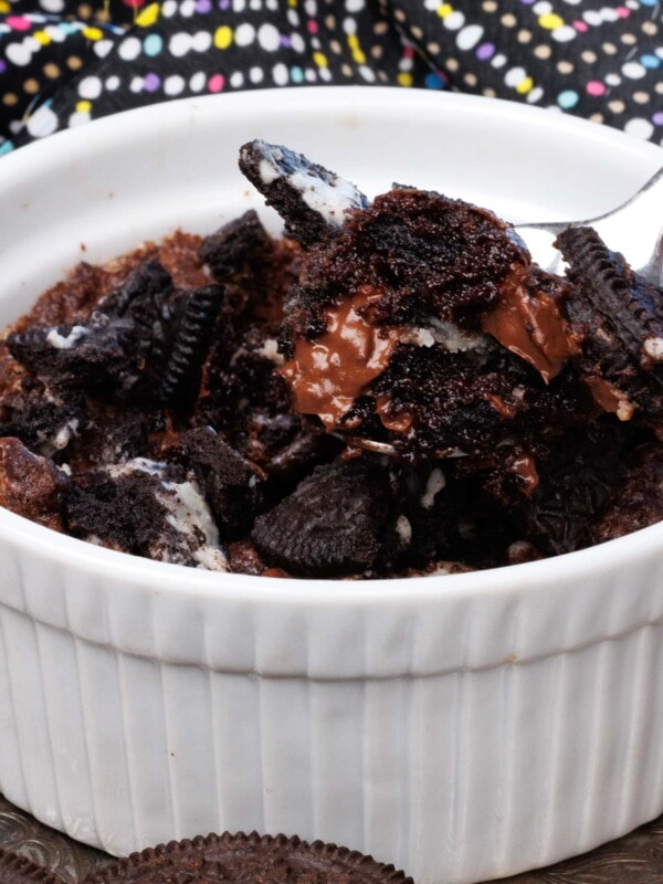 one oreo brownie in a white ramekin with a spoon on the side