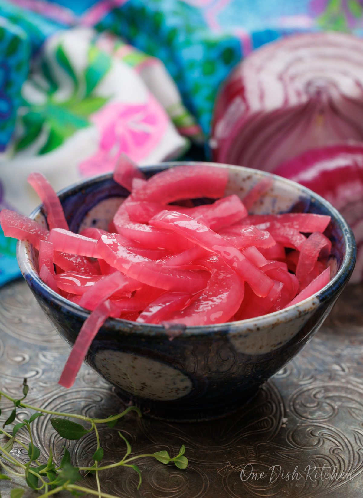 a small bowl filled with red pickled onions.