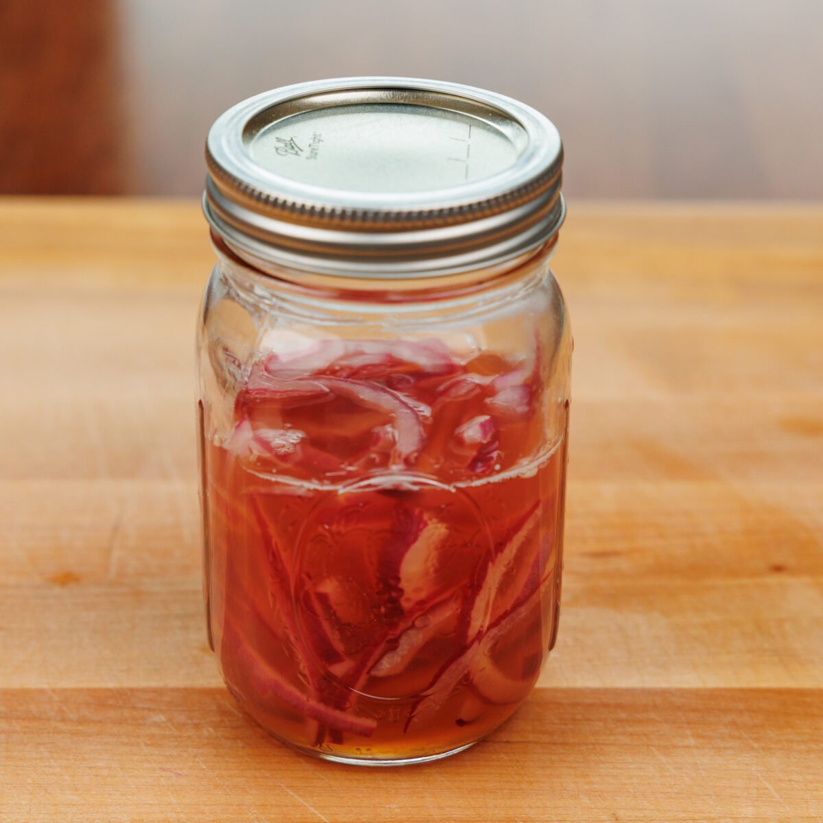 pickled red onions in a mason jar.