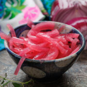 a small bowl filled with red pickled onions