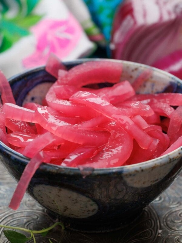 a small bowl filled with red pickled onions