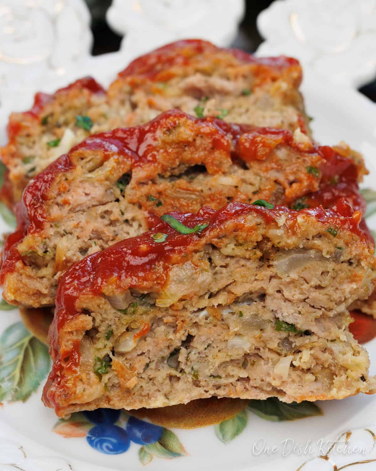 three slices of turkey meatloaf on a white plate.