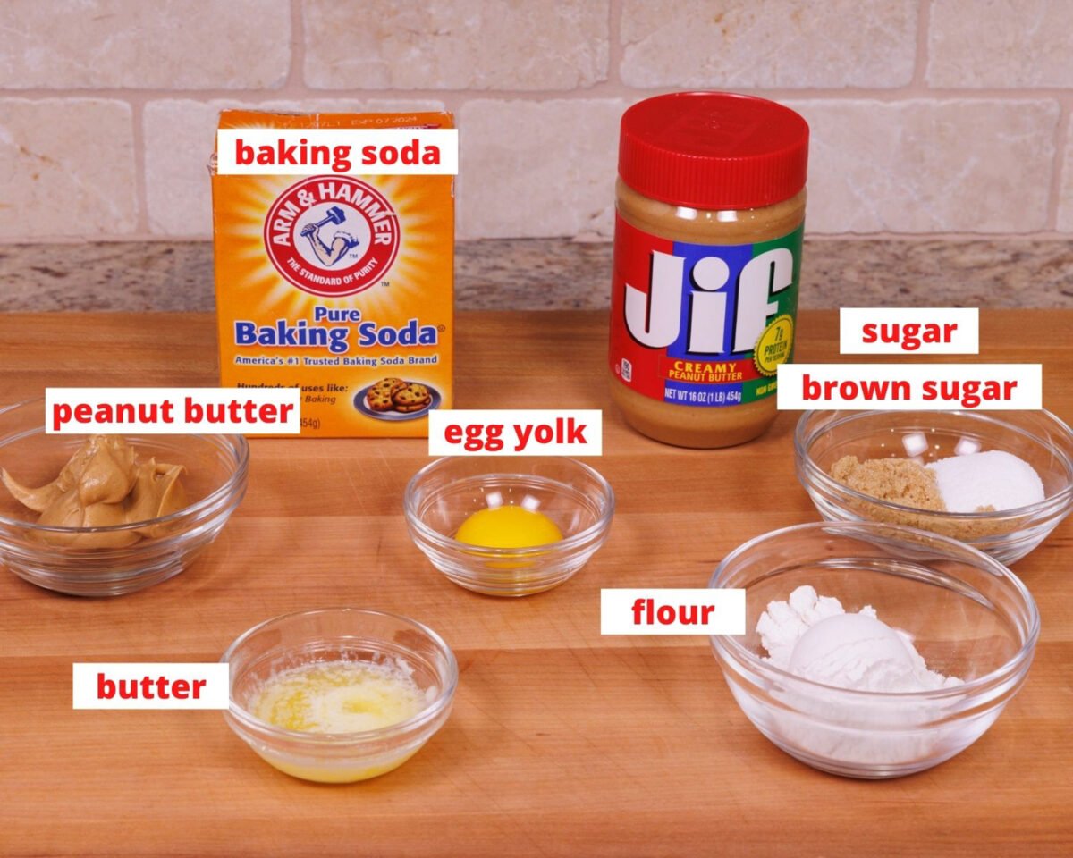 ingredients needed to make a deep dish peanut butter cookie on a wooden counter.