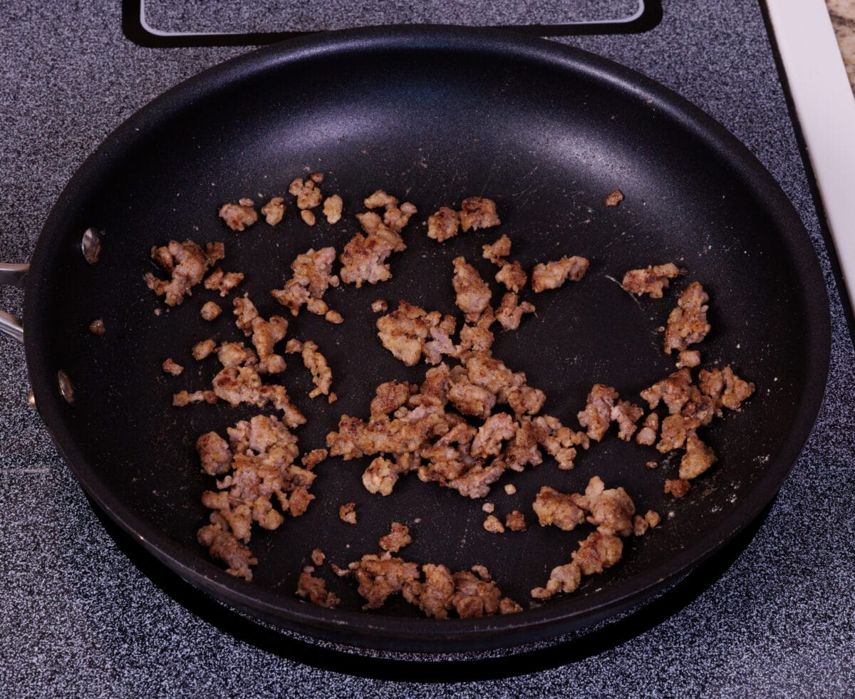 sausage browning in a skillet.