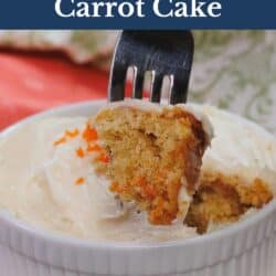 a small carrot cake topped with cream cheese frosting in a white ramekin.