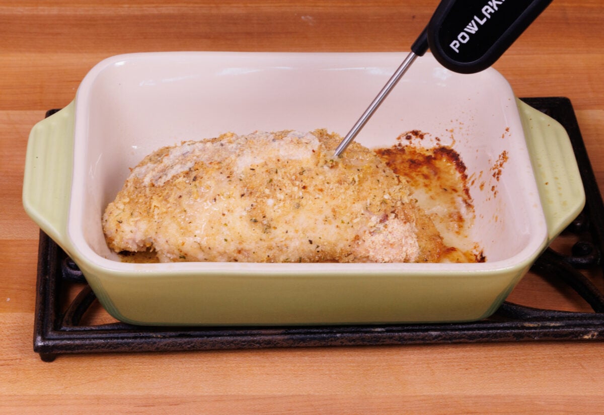 baked chicken cordon bleu with an instant read thermometer in then center.