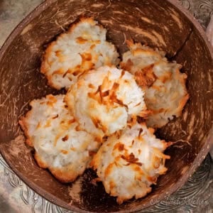 a small batch of coconut macaroons in a brown bowl.