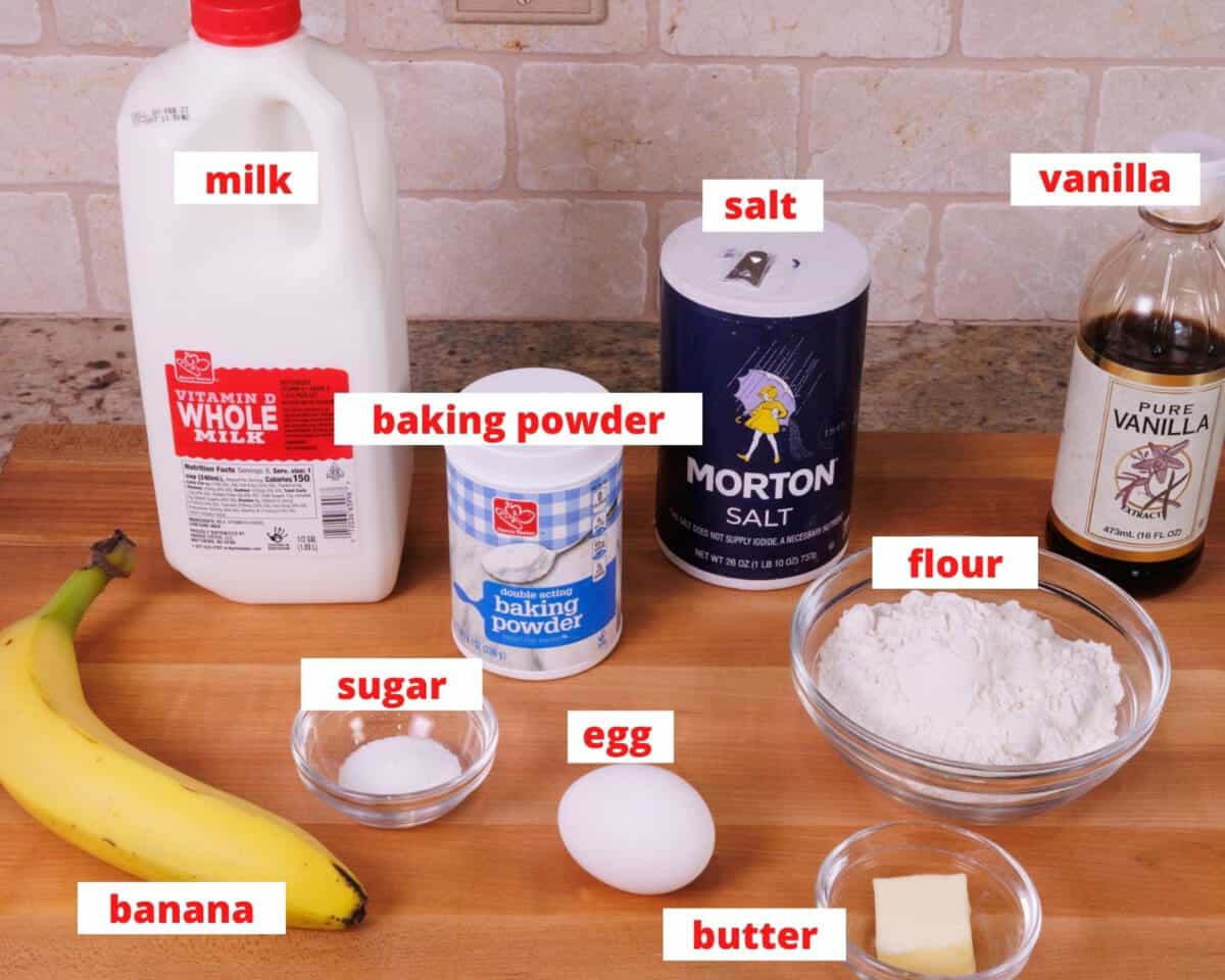 banana pancakes ingredients on a wooden cutting board in a kitchen.