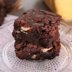 a small batch of brownies with crackly tops on a white plate.