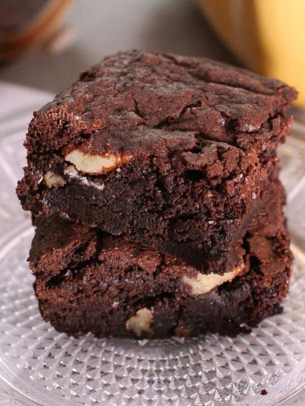 a small batch of brownies with crackly tops on a white plate.