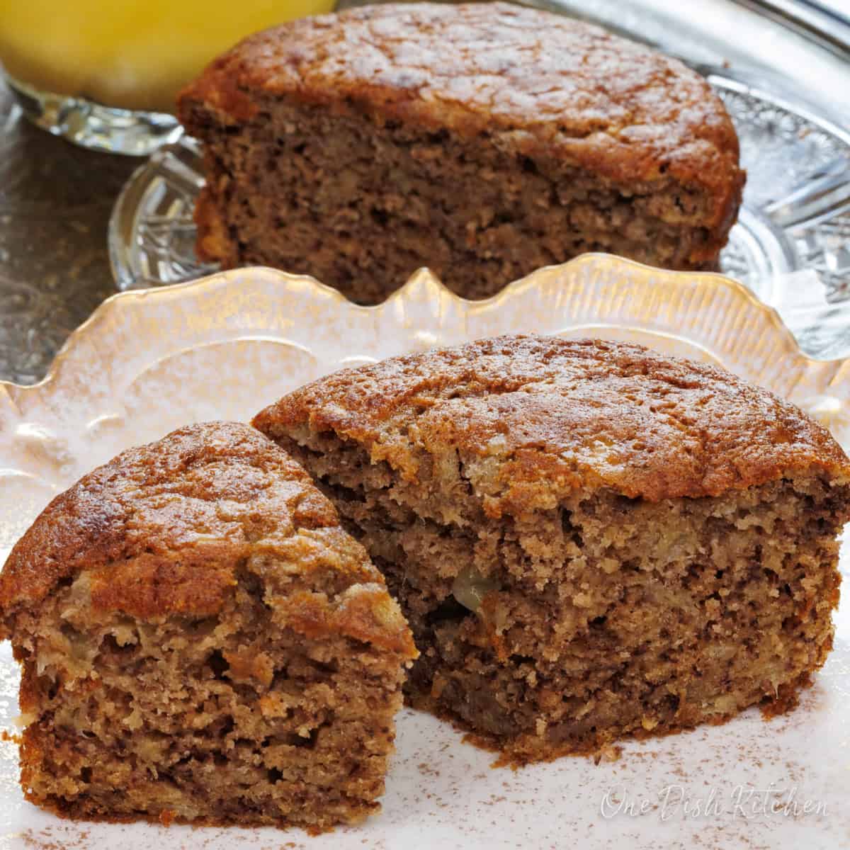 a small loaf of banana bread sliced on a plate.