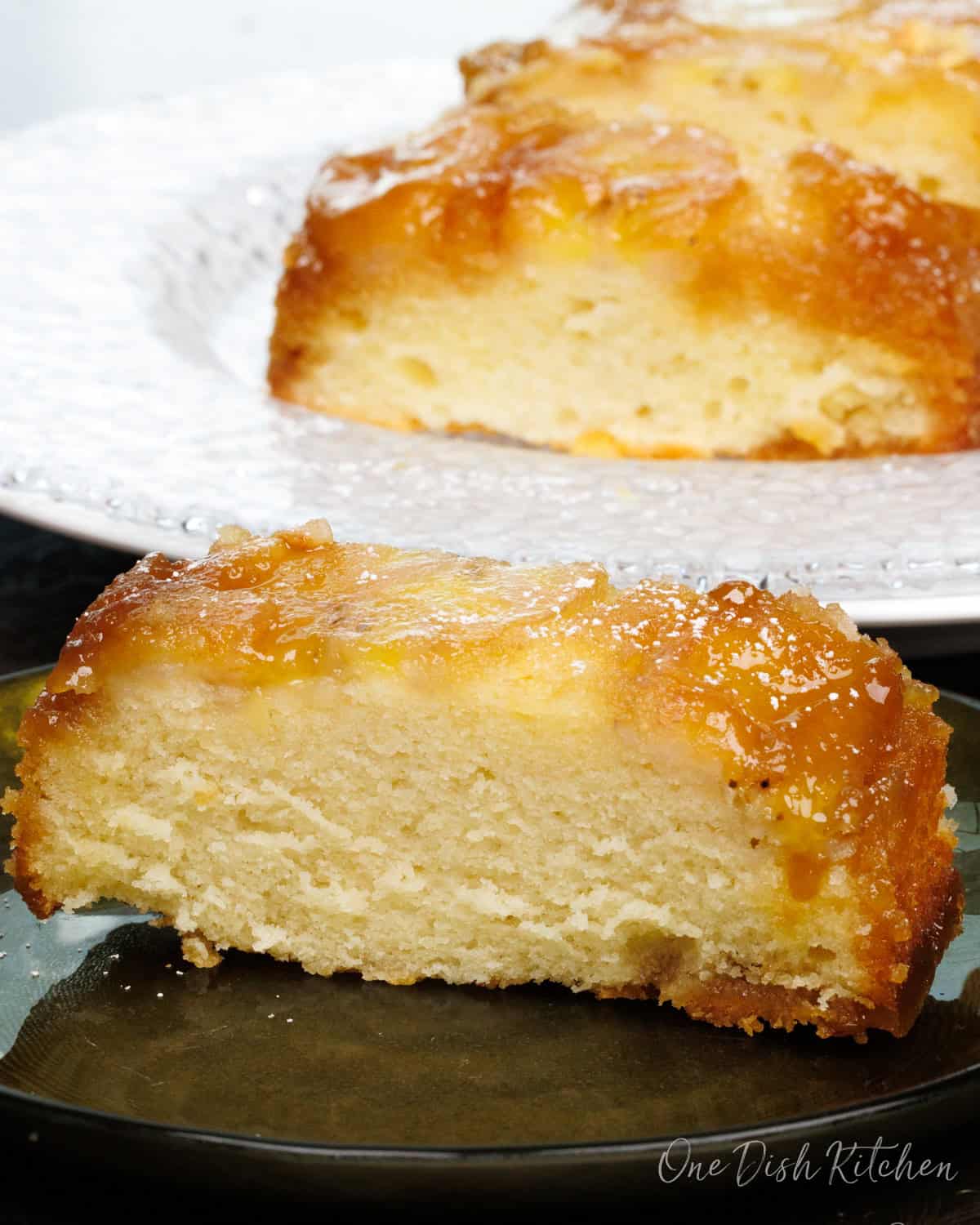 a small banana upside down cake on a green plate.