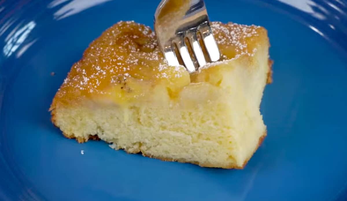 a slice of banana upside down cake on a blue plate