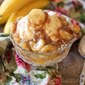 bananas foster for one person in a dessert dish over vanilla ice cream.
