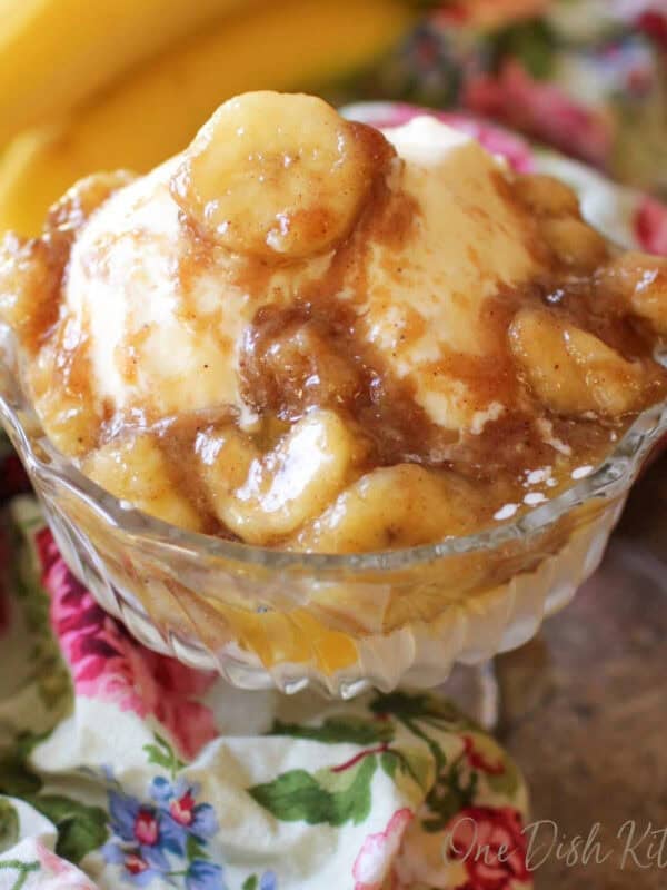 bananas foster for one person in a dessert dish over vanilla ice cream.