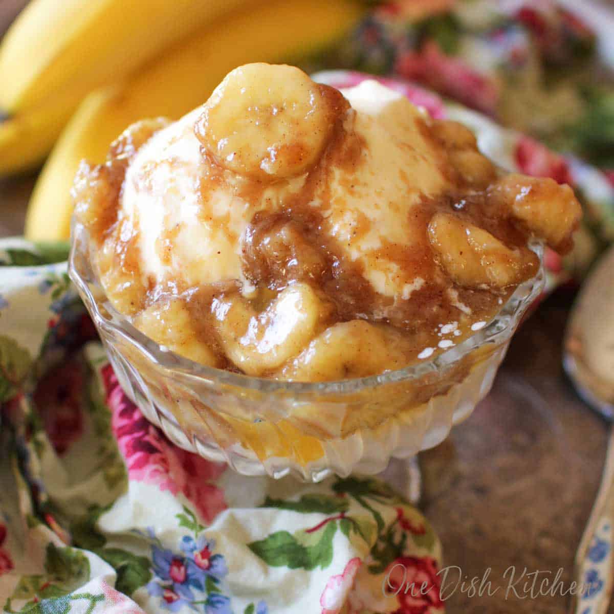 bananas foster for one person in a dessert dish over vanilla ice cream.