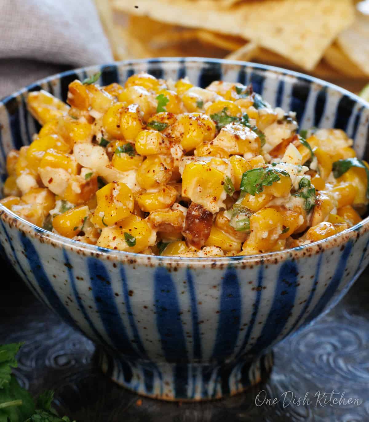 a blue bowl filled with mexican street corn