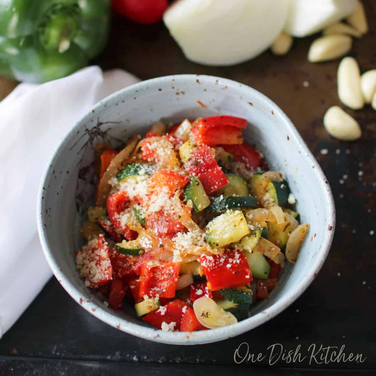 a single serving of ratatouille in a blue bowl.