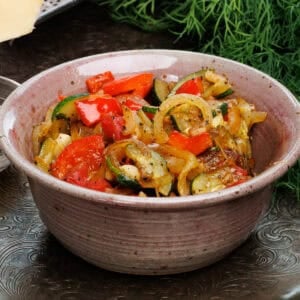 a bowl of ratatouille on a silver tray.