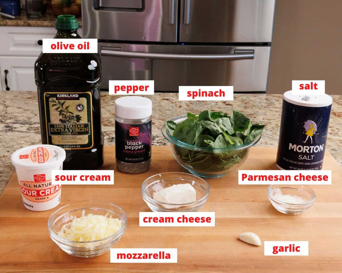 spinach dip ingredients on a kitchen counter.