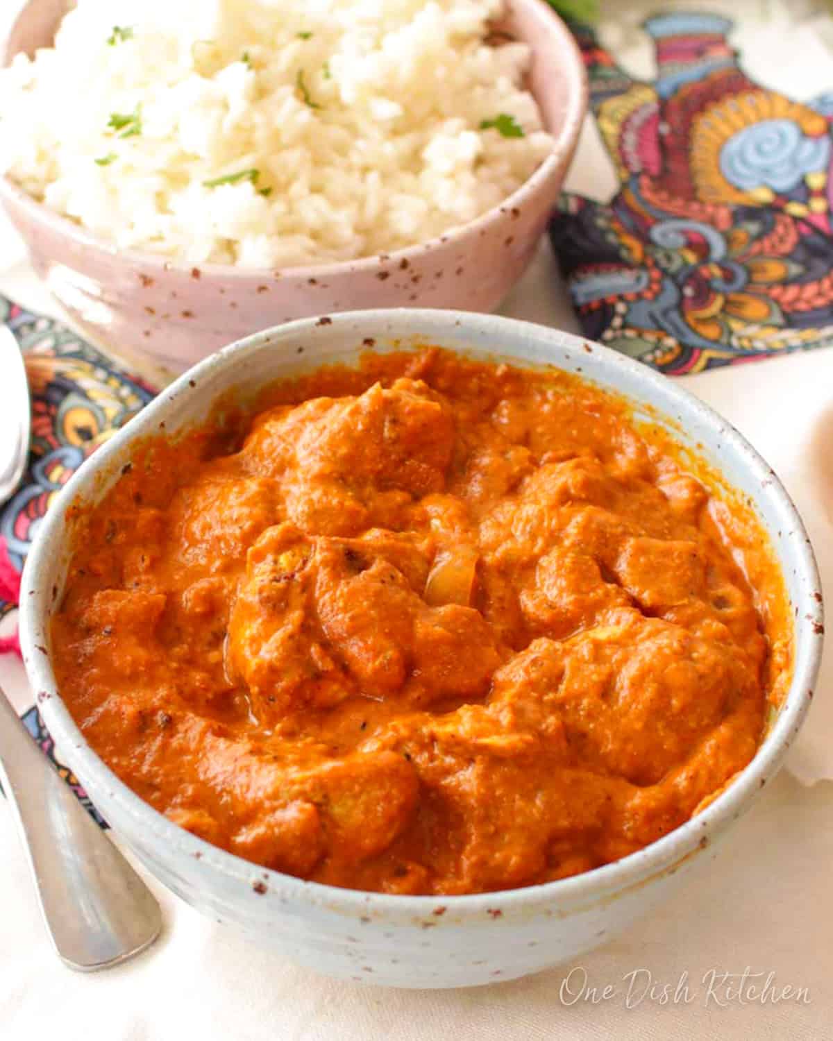 butter chicken in a small blue bowl.