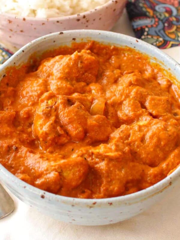butter chicken in a small blue bowl.