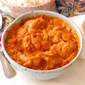 butter chicken in a small blue bowl.