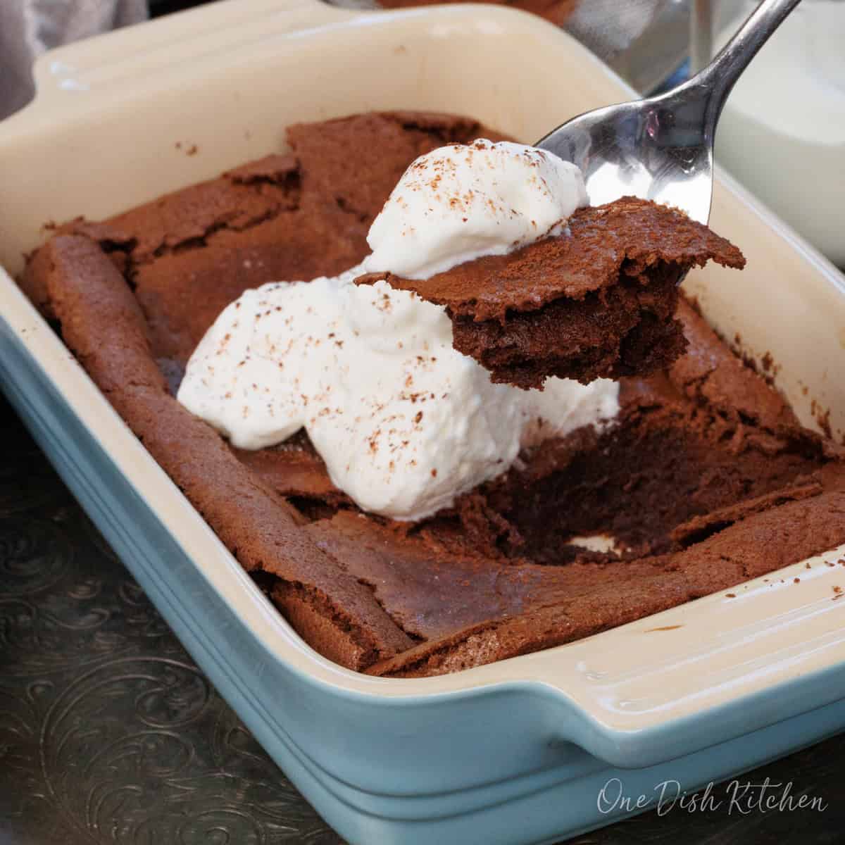 a flourless chocolate cake topped with whipped cream.