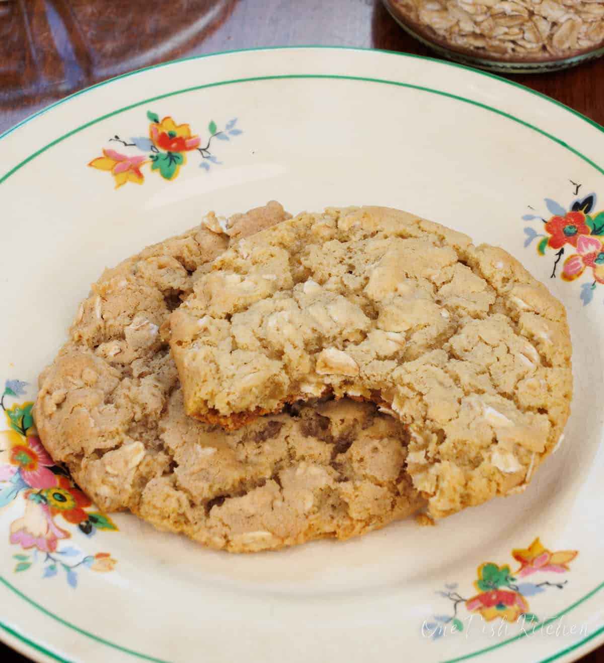 two half eaten oatmeal cookies on a plate