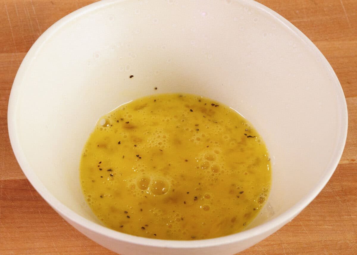 scrambled eggs in a white bowl.